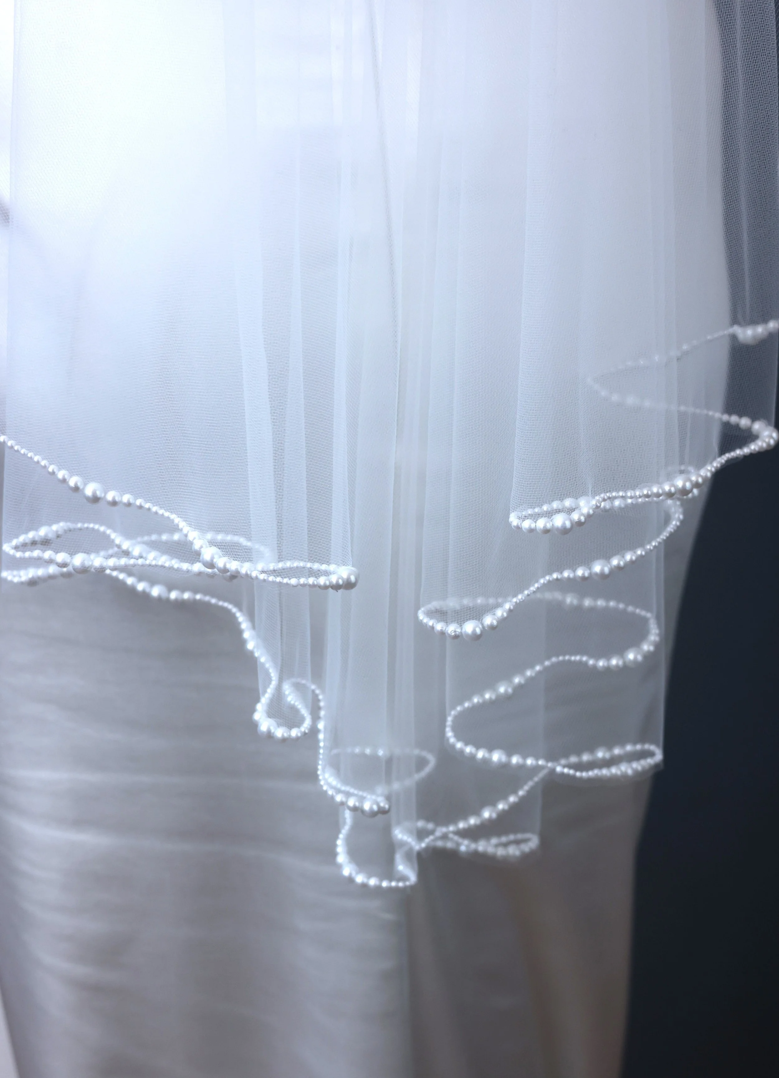 Pearl trimmed wavy cut fingertip length Maho Bay bridal veil by